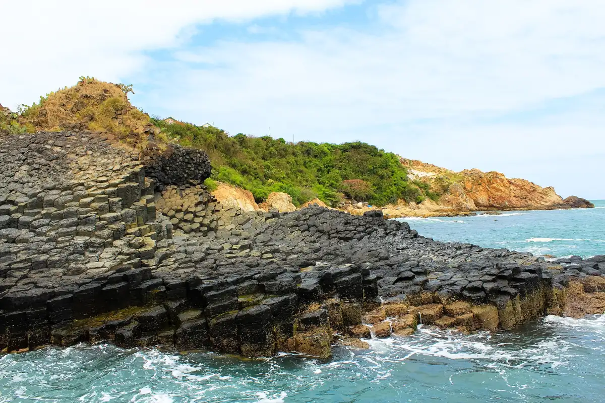 The basalt headland of Ganh Da Dia with green scrub